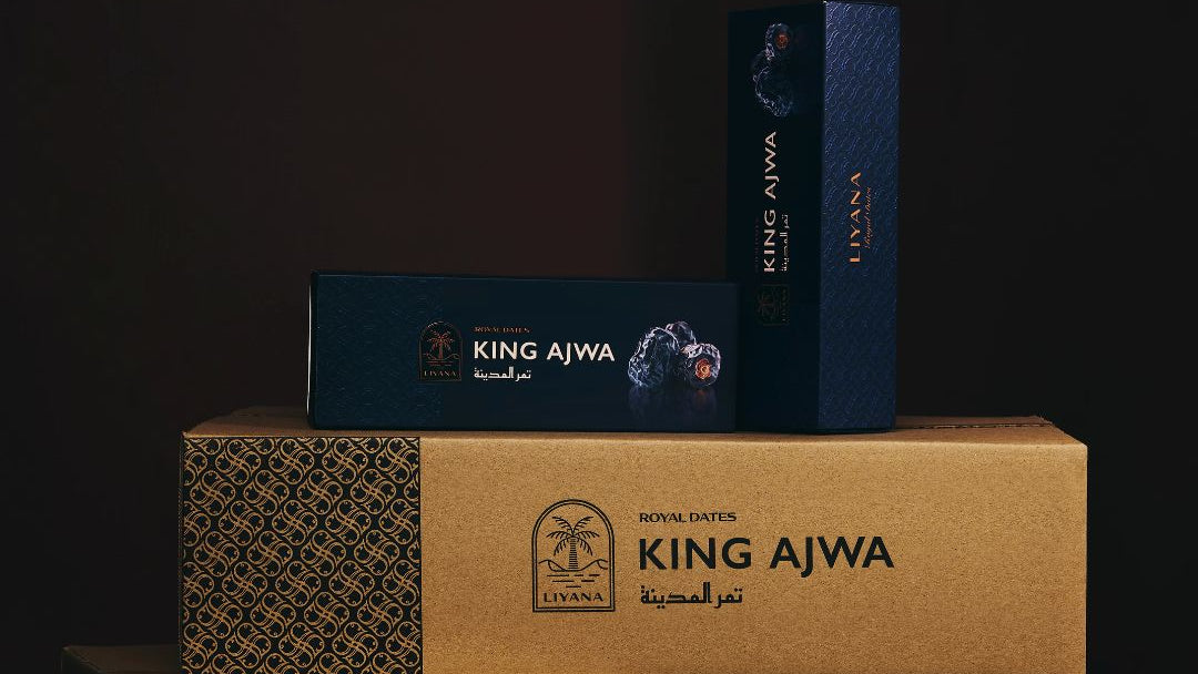Stack of King Ajwa boxes on a dark background