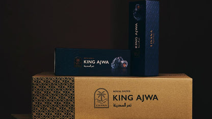 Stack of King Ajwa boxes on a dark background